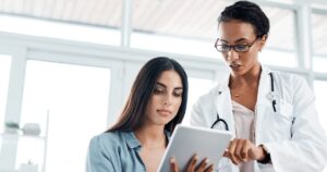Woman and medical professional going over pregnancy test results